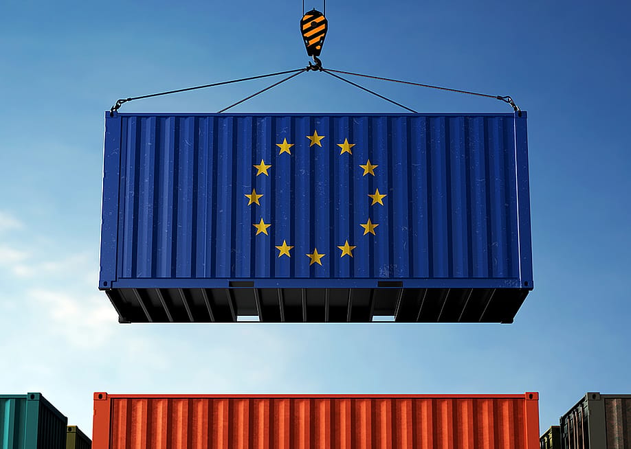 An azure blue freight container showing the European Union flag's 12 gold stars. — zmotions // Shutterstock