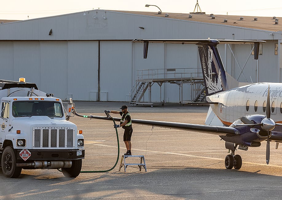 Aircraft staff refuels a private plane. — TommyLeiSun // Shutterstock