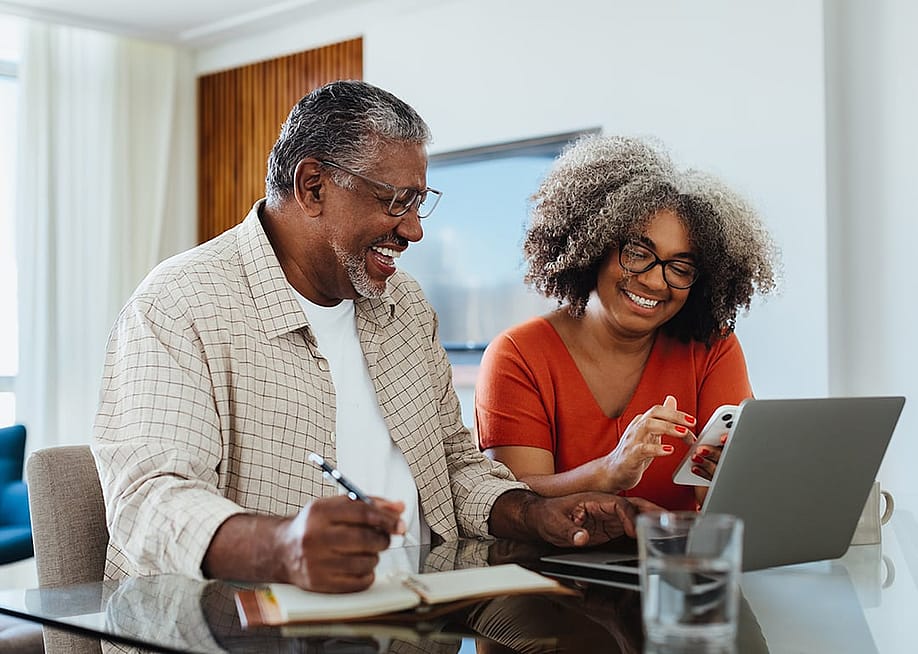An elderly couple planning their budget and finances at home. — JLco Julia Amaral // Shutterstock
