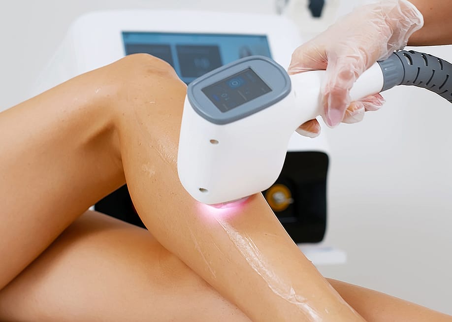 A cosmetologist doing a laser hair removal to a patient in a beauty clinic. — wedmoments.stock // Shutterstock