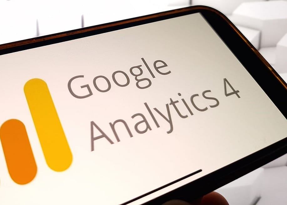 The Google Analytics 4 platform logo displayed on a smartphone. — Piotr Swat // Shutterstock