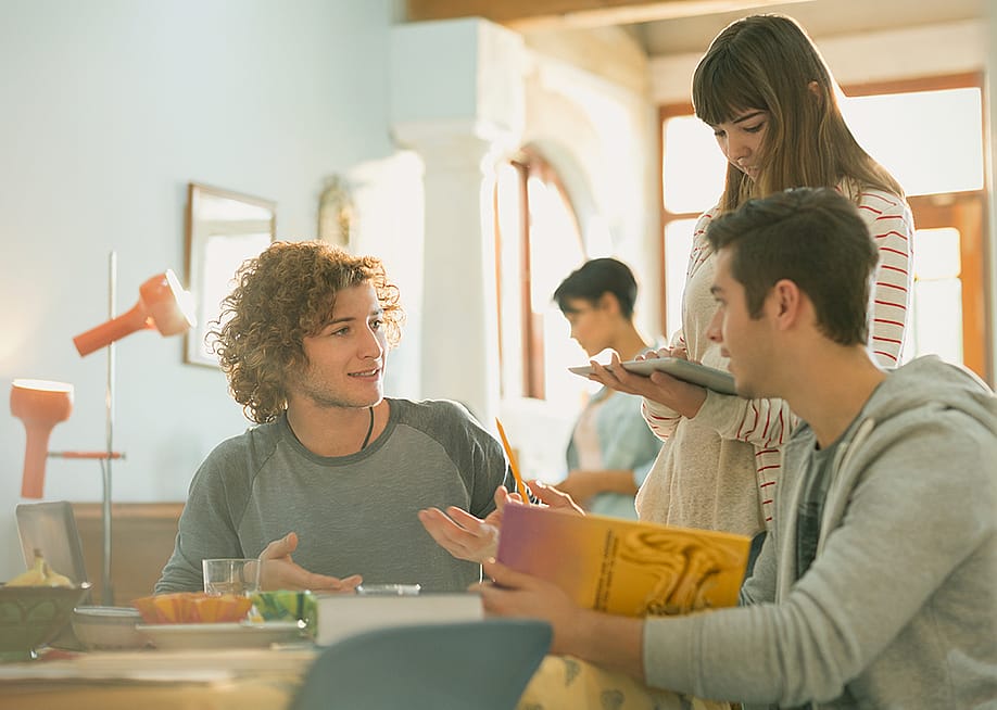 A group of college students having a conversation. — KOTOIMAGES // Shutterstock