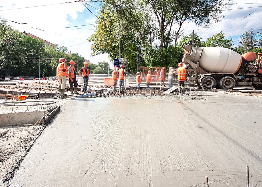 Construction workers doing road works and tram tracks repair. — Kirill Neiezhmakov // Shutterstock