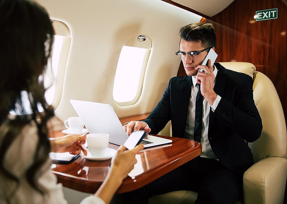 Businessman on a call while on a private flight. — My Ocean Production // Shutterstock