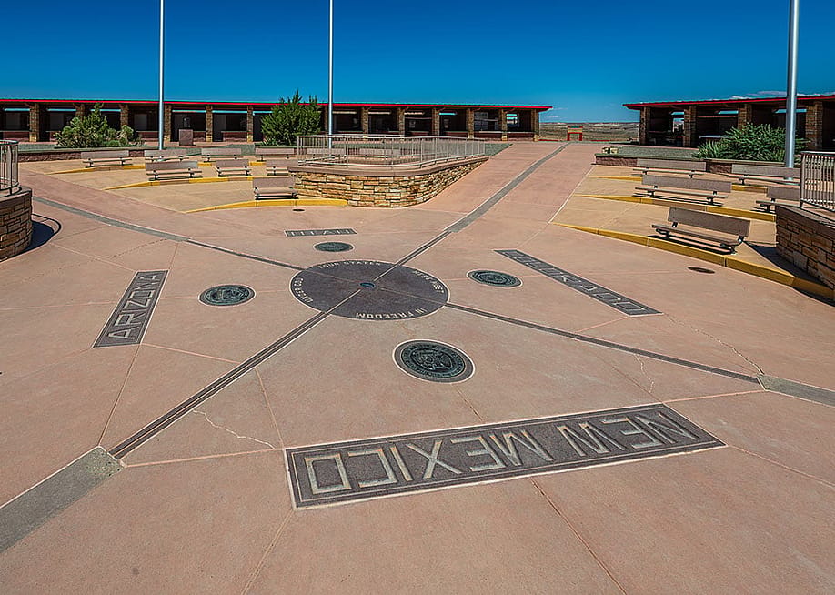 The Four Corners Monument marks the quadripoint in the Southwestern United States where the states of Arizona, Colorado, New Mexico, and Utah meet. — Ondrej Bucek // Shutterstock
