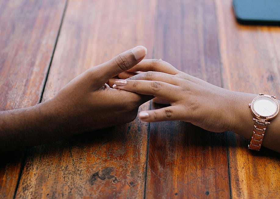 Two hands holding each other. — Ebinsnaps 123 // Shutterstock