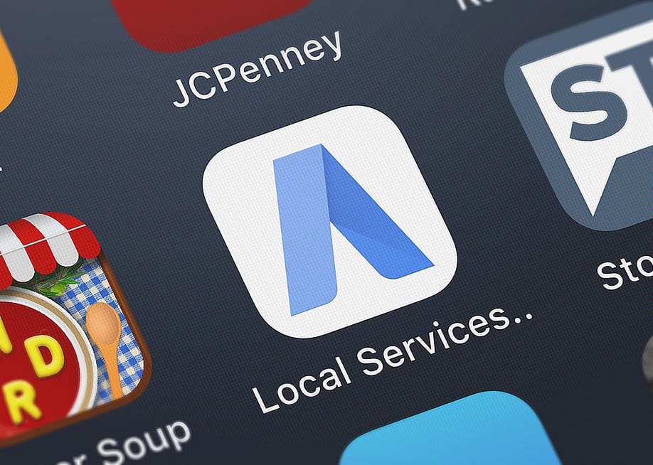 Google Ads mobile app icon displayed on a smartphone. — OpturaDesign // Shutterstock