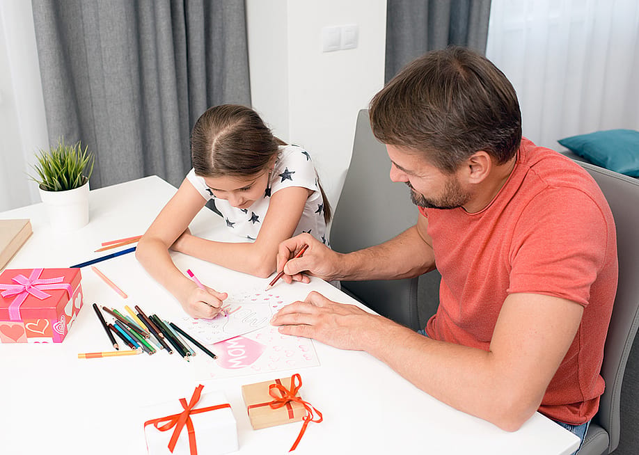 A father and daughter do arts and crafts for Mother's Day. — SeventyFour // Shutterstock