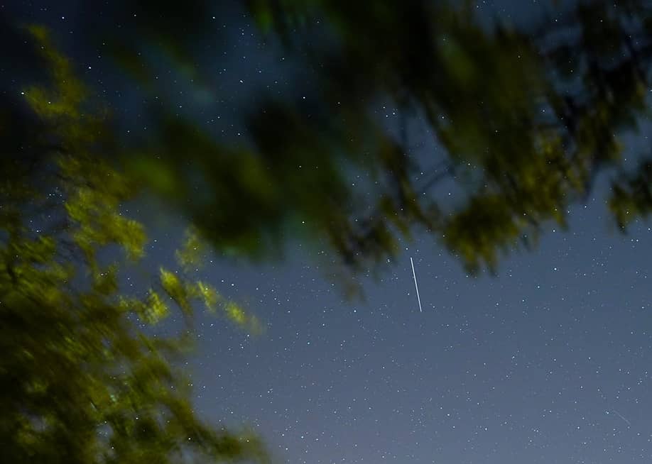 A satellite from a larger group of satellites called Starlink seen trailing across the night sky. — Ian Forsyth // Getty Images