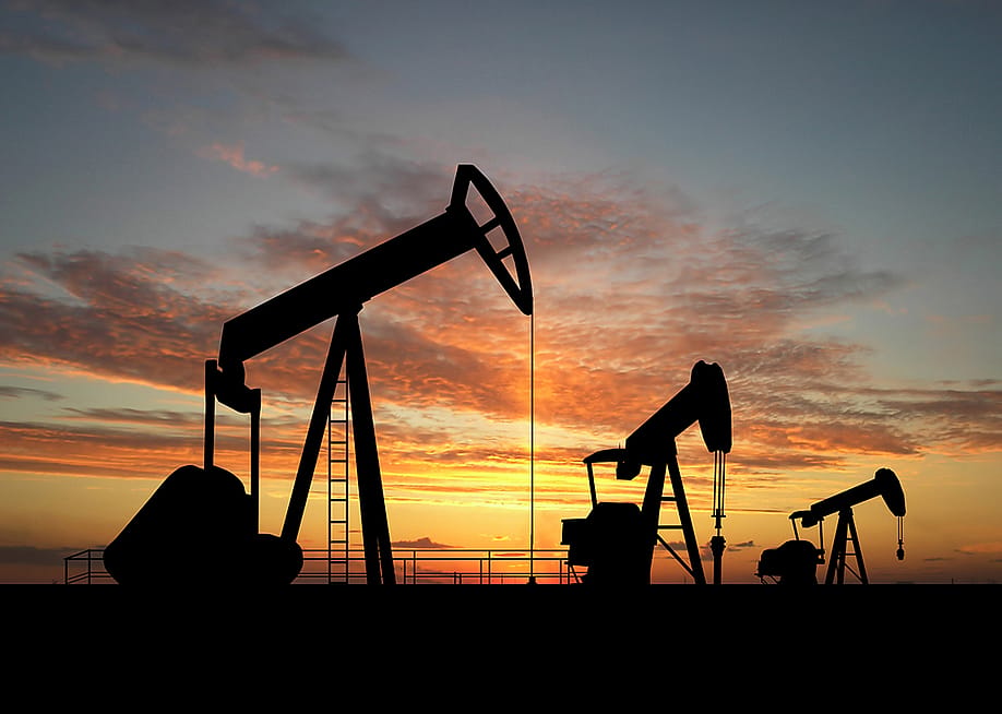 Silhouette of gas pumps machinery during sunset. — TebNad // Shutterstock