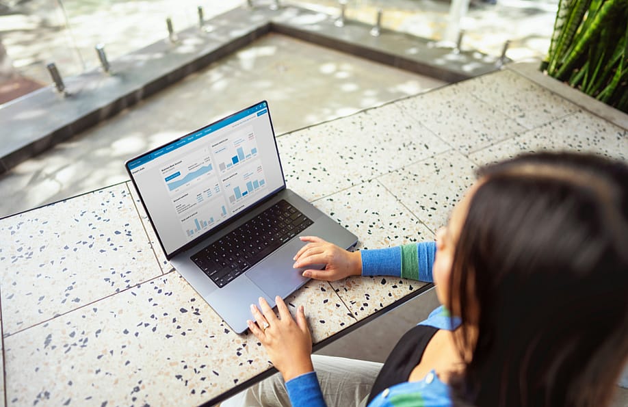 A person checking financial graphs and charts from a laptop. — Xero