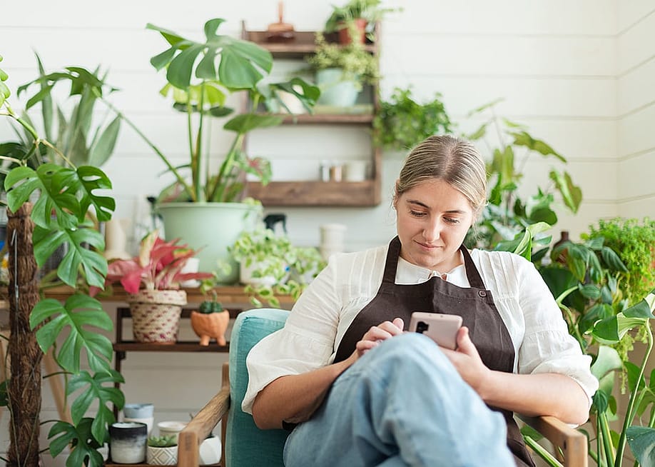 A female small garden business owner browsing information using a smartphone. — Rawpixel.com // Shutterstock