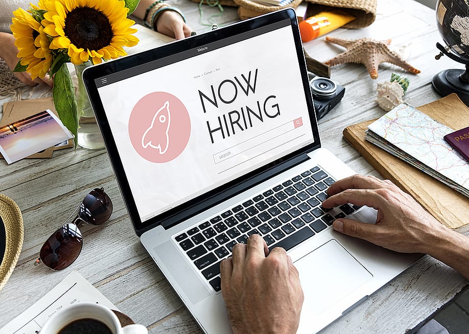 A person checking job opportunities online from a laptop. — Rawpixel.com // Shutterstock