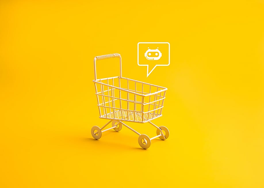 A shopping cart with a AI chatbot icon in a yellow background. — tete_escape // Shutterstock
