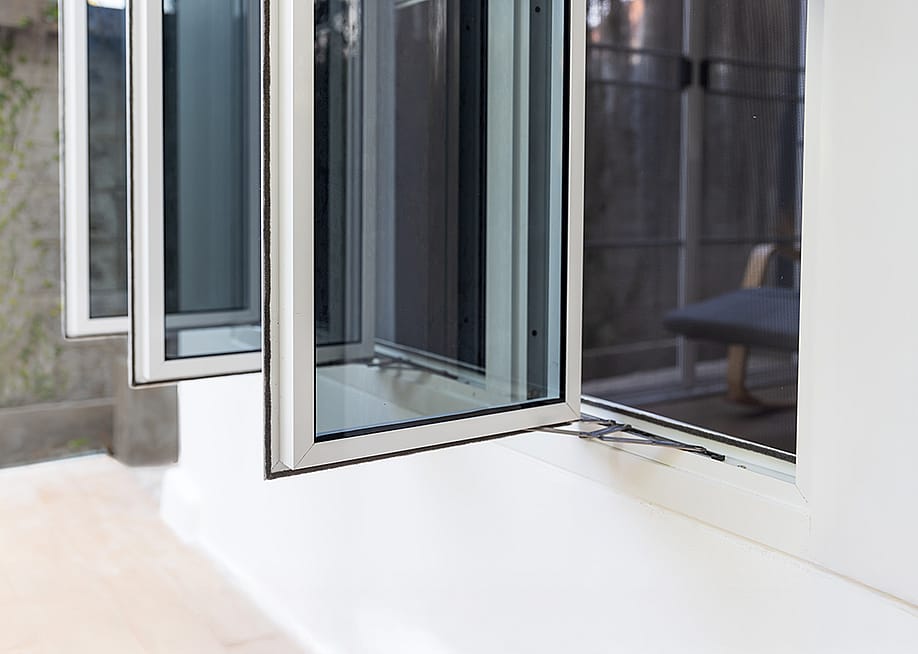 Three panel aluminum casement window installed in a home wall. — Toa55 // Shutterstock