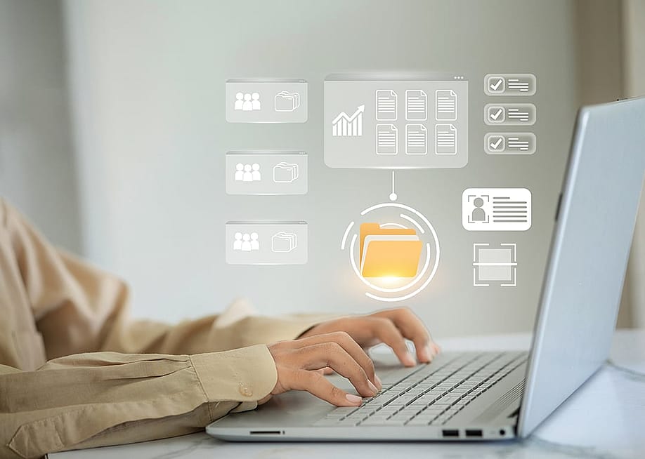 A person checking through virtual file folders from a laptop. — vittaya pinpan // Shutterstock