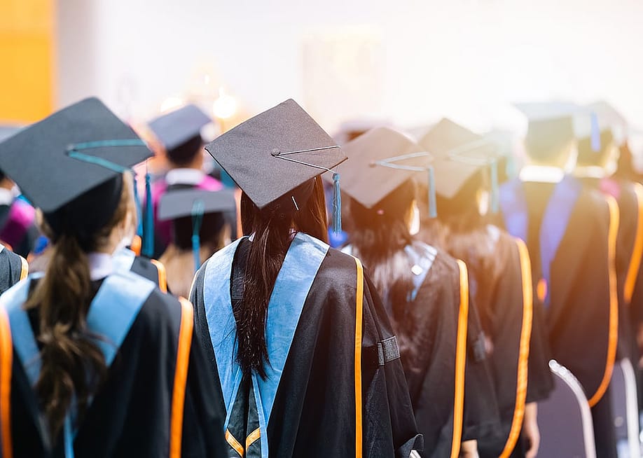 University graduating students lined up during commencement day. — Education StockPhoto // Shutterstock