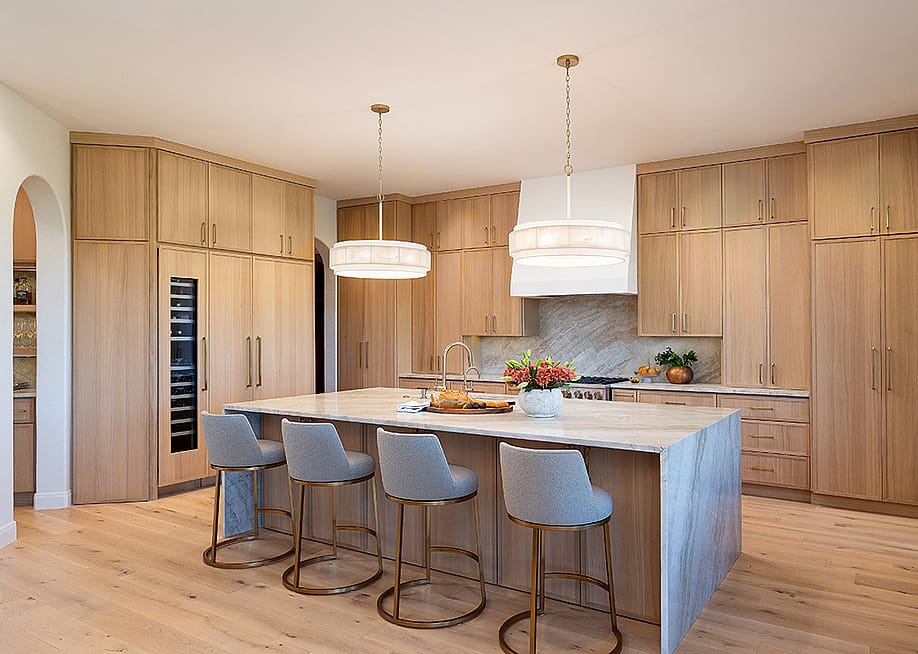 Contemporary kitchen with light wood flooring and cabinets. — Design by CROSS; Photography by Joshua Nolden