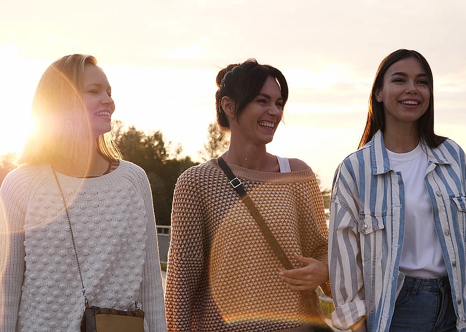 A group of friends enjoying a good time and walking down a waterfront. — FunKey Factory // Shutterstock