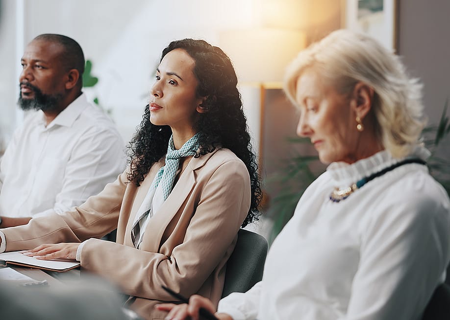 Business people listening during a meeting on planning a startup business. — PeopleImages // Shutterstock