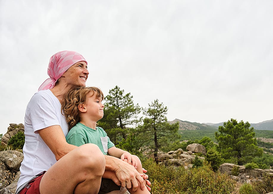 A cancer patient enjoying their time in nature with her child. — roberjzm // Shutterstock