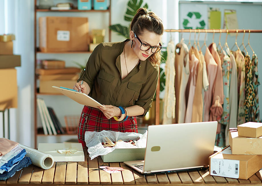 A female small business owner checking a customer's order from a laptop. — Alliance Images // Shutterstock