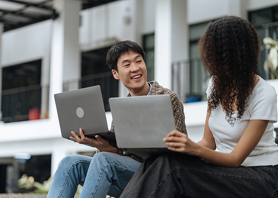 University students sharing conversations outdoors in the campus. — THICHA SATAPITANON // Shutterstock