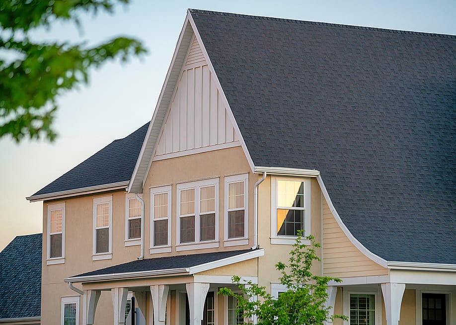 A two-story residential house with gray roofing. — Wirestock Creators // Shutterstock