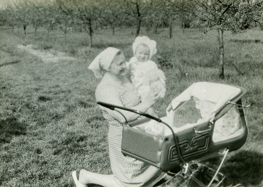 A vintage photo of a grandmother with her grandchild outdoors. — Elzbieta Sekowska // Shutterstock