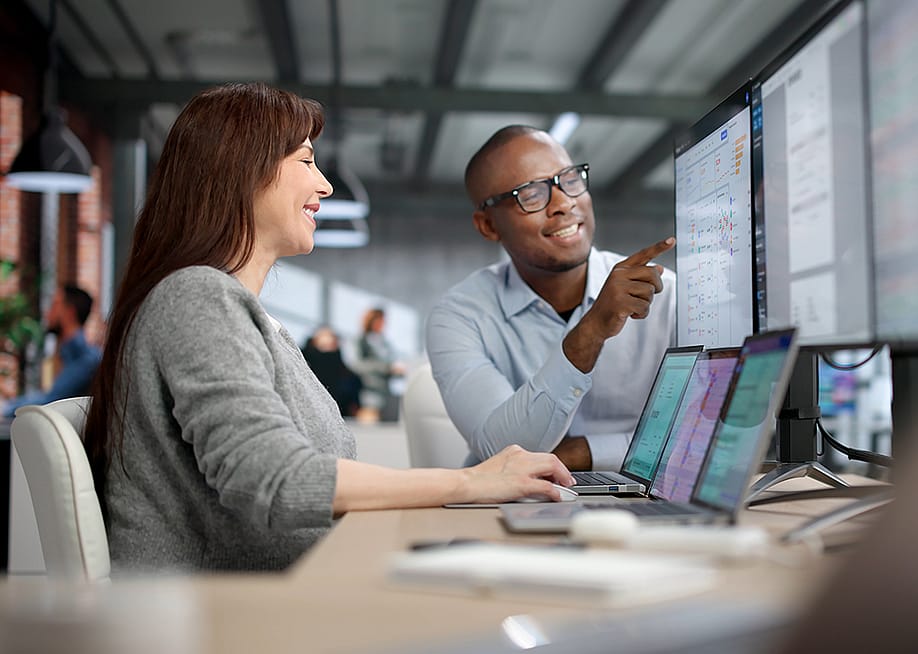 Two auditors carefully review financial data on a computer screen. — Andrey_Popov // Shutterstock