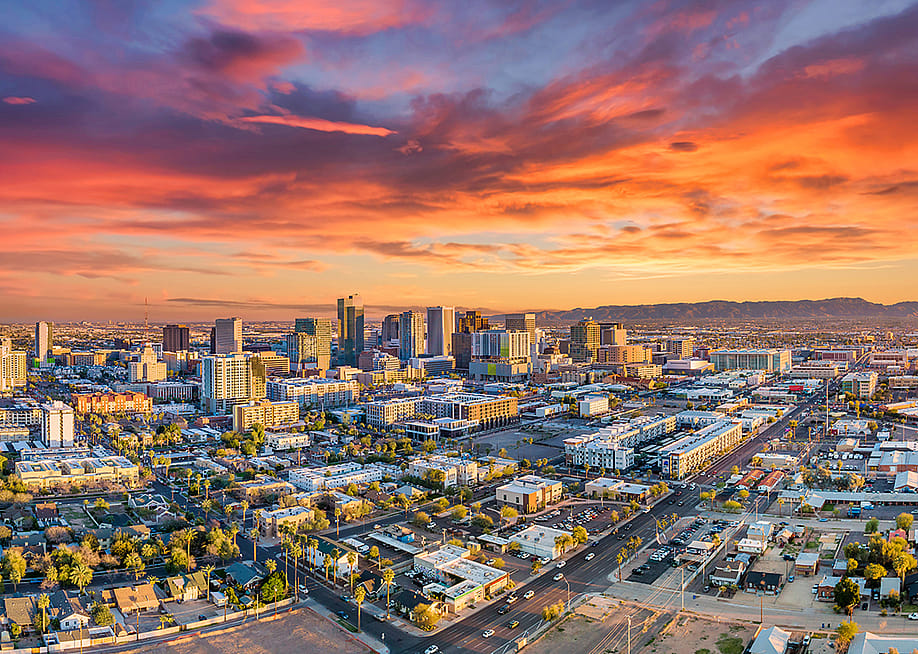 An aerial view of Phoenix's downtown skyline in Arizona during sunset. — Kevin Ruck // Shutterstock