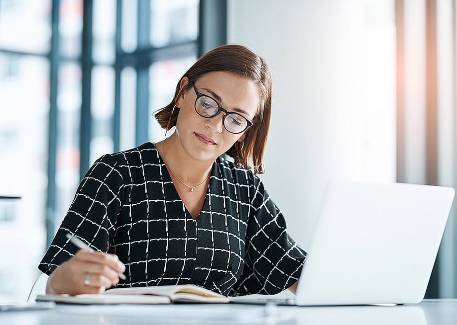 An office employee drafting a proposal for a stakeholder organization. — PeopleImages // Shutterstock