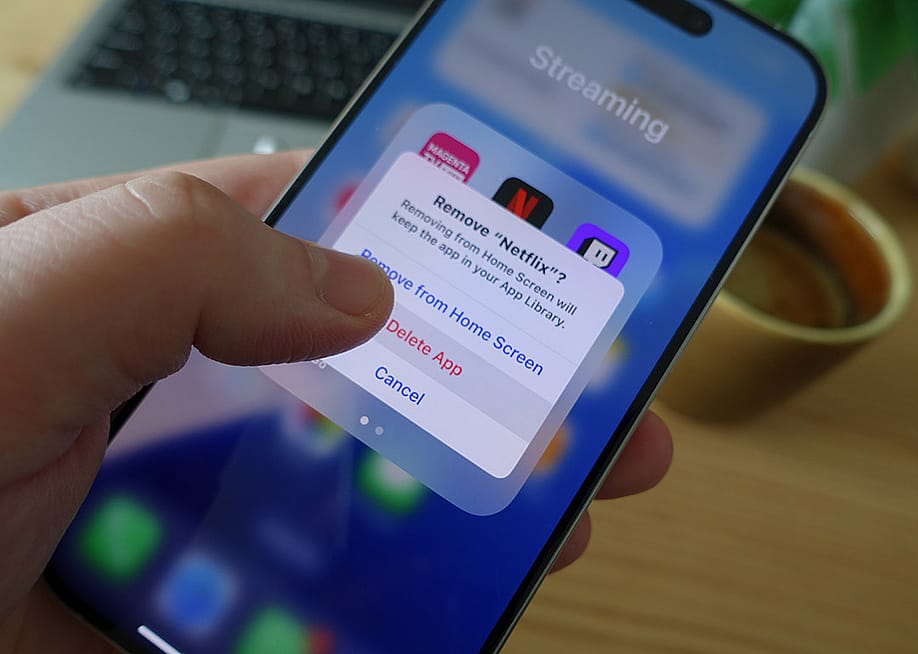 A user prompting to delete Netflix app from his smartphone's screen. — Bendix M // Shutterstock