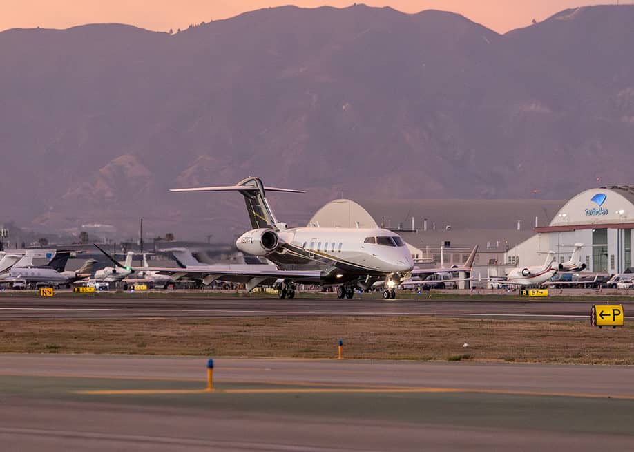 A Bombardier Challenger 3500 aircraft landing on runway in Van Nuys Airport in California. — Ed Saldana // Shutterstock