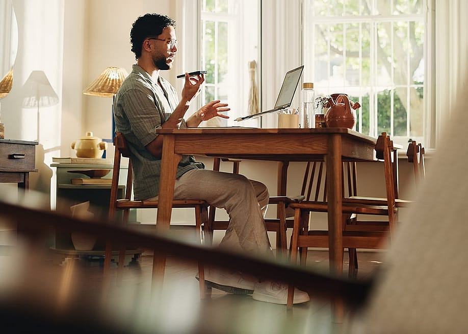 A businessman working from home and talking on the phone. — PeopleImages // Shutterstock