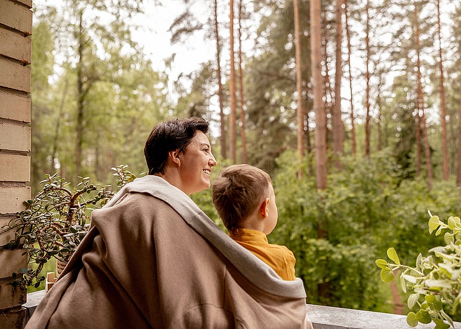 A grandmother enjoying outdoor view with her young grandson. — Creative_Bird // Shutterstock