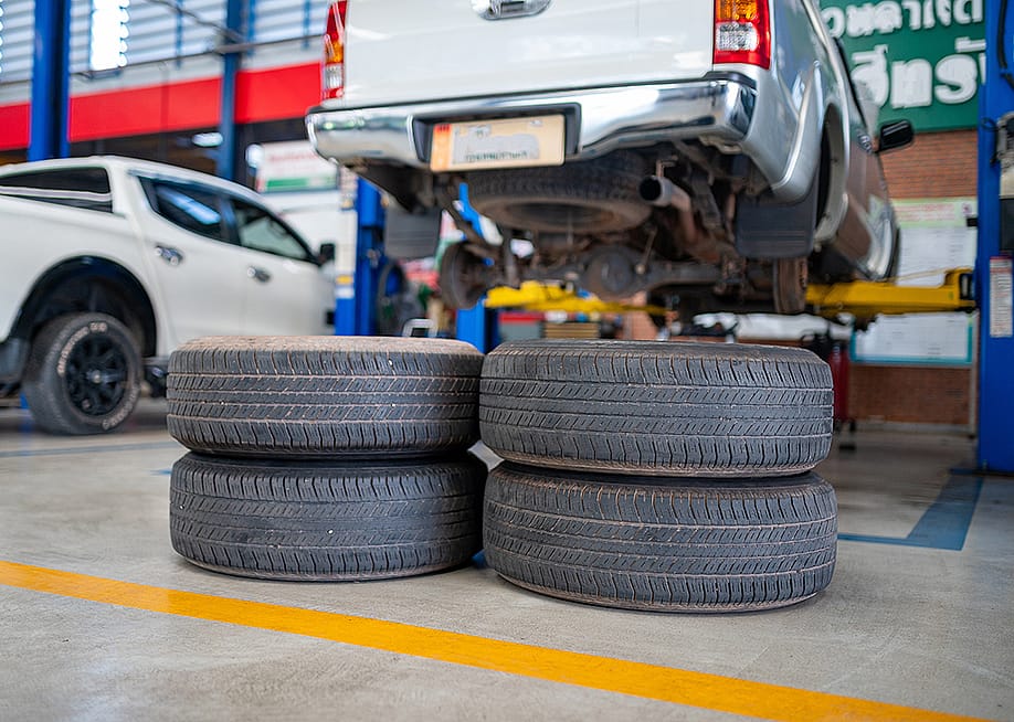 A stack of used tires in an auto repair shop. — Somchai_Stock // Shutterstock