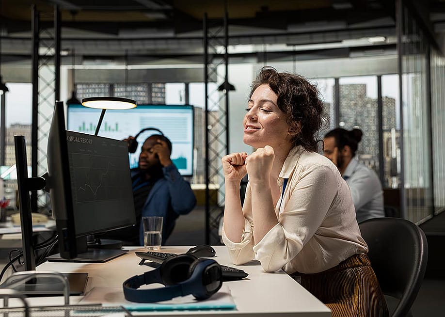 An employee appearing to be pleased after stock exchange's charts go upward. — DC Studio // Shutterstock