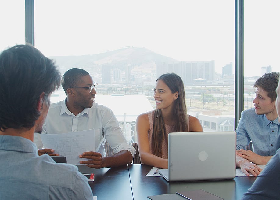 A business team in a boardroom together. — Monkey Business Images // Shutterstock