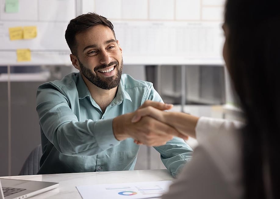 Business partners shaking hands after closing a business account deal. — fizkes // Shutterstock