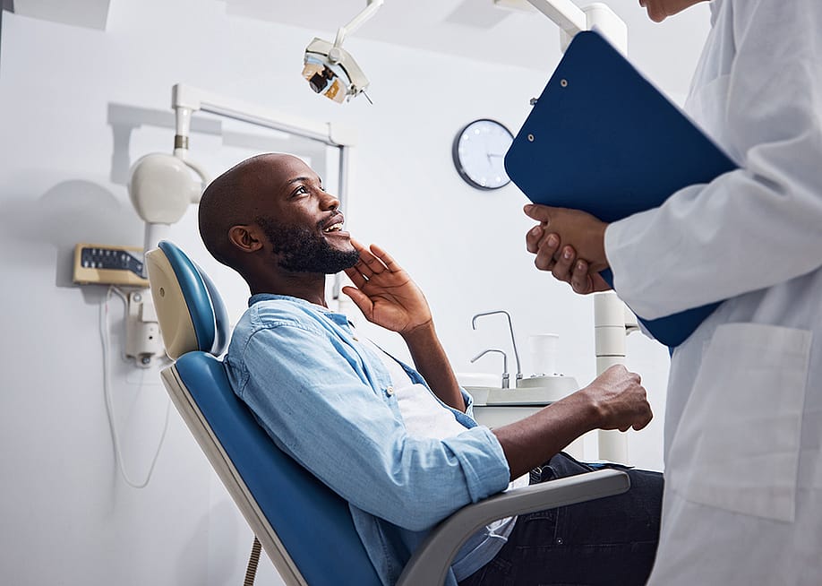 A relieved patient at the dentist during an appointment. — PeopleImages // Shutterstock
