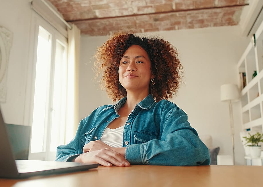 A young adult working remotely from her cozy home workspace. — Andrii Nekrasov // Shutterstock