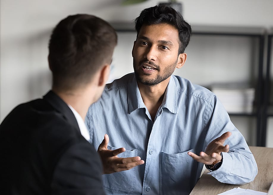 A young businessman consulting with a financial advisor. — fizkes // Shutterstock