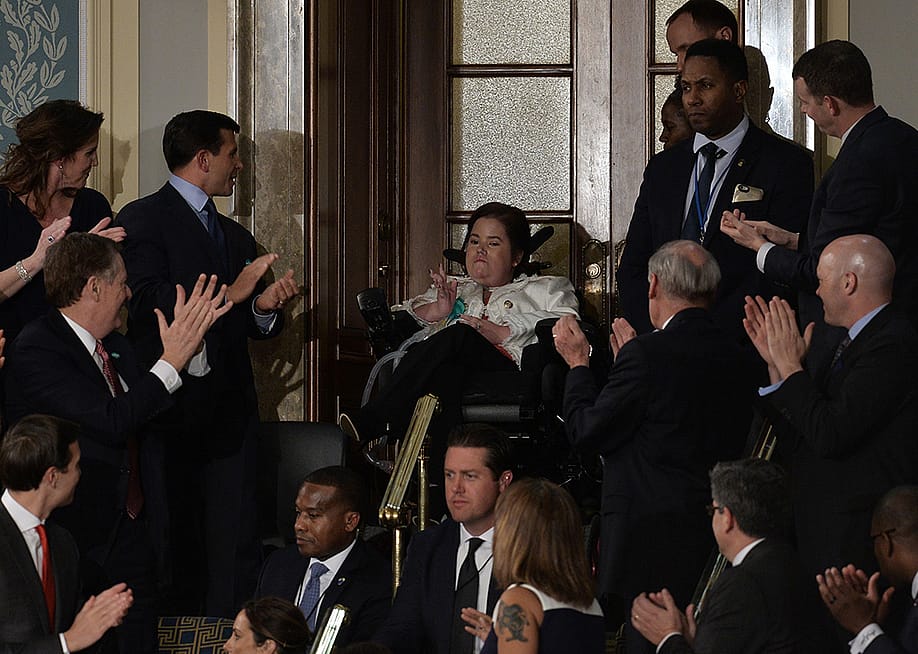 Megan Crowley (C), a Pompe Disease patient, applauded as US President Donald Trump addresses a joint session of the US Congress on February 28, 2017 at the Capitol in Washington, DC. — ANDREW CABALLERO-REYNOLDS // AFP via Getty Images