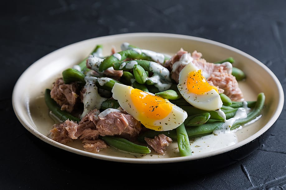 A tuna and green bean salad with boiled egg. — Ruslan Mitin // Shutterstock