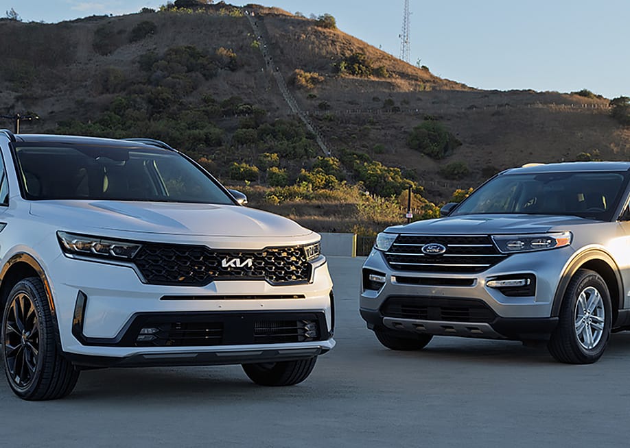 Ford Explorer and Kia Sorento cars parked outdoors. — CarMax