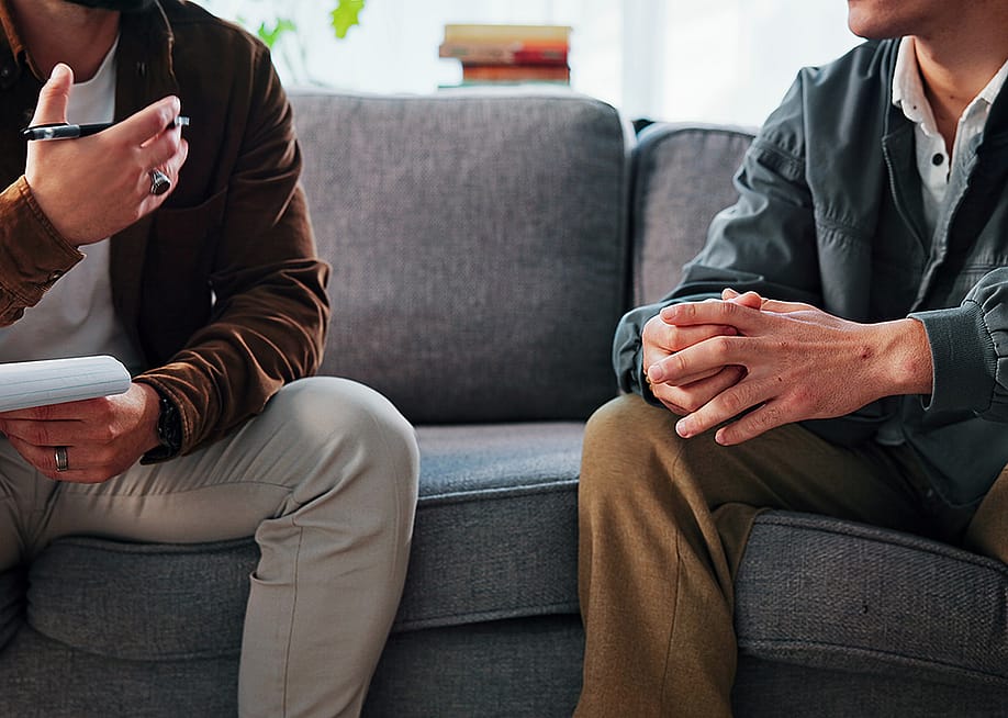 A psychologist discussing evaluation to a patient during a clinic counseling session. — PeopleImages // Shutterstock