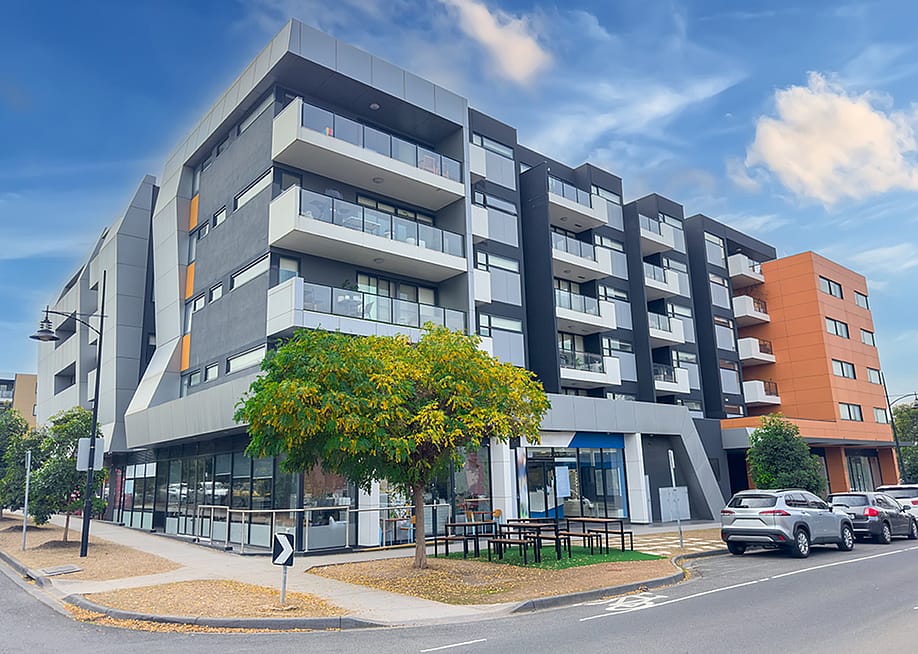 A multi-story residential apartment building situated in Melbourne, Australia. — Elias Bitar // Shutterstock