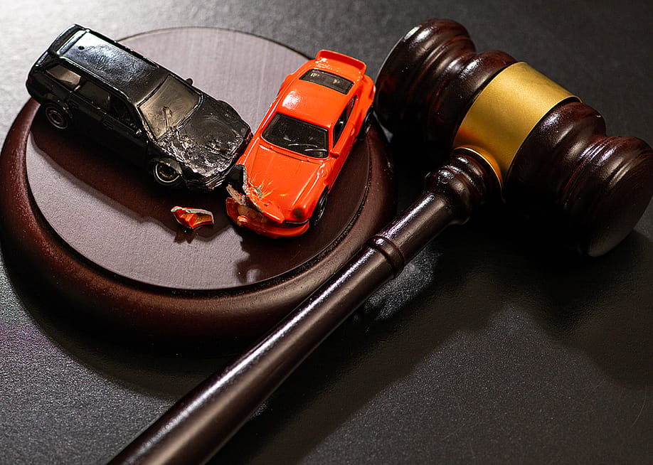 Figures of crashed cars and a gavel as a concept of traffic court civil litigation. — Faces Portrait // Shutterstock