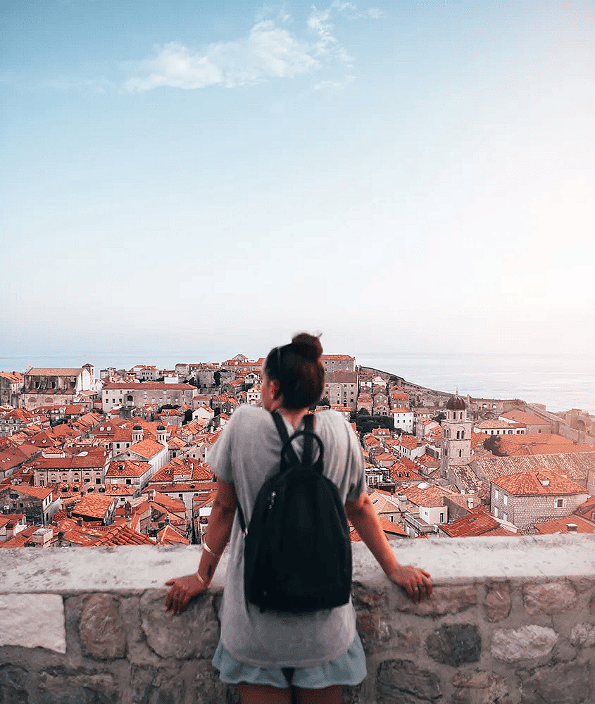 A young tourist looking over red-brownish roofs from Old Town in Dubrovnik, Croatia. — Courtesy of EF Ultimate Break